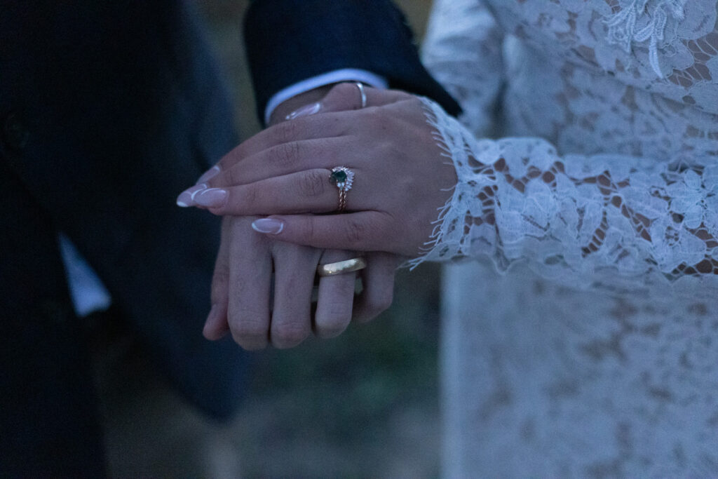 Two hands on top of each other showing off wedding rings. 