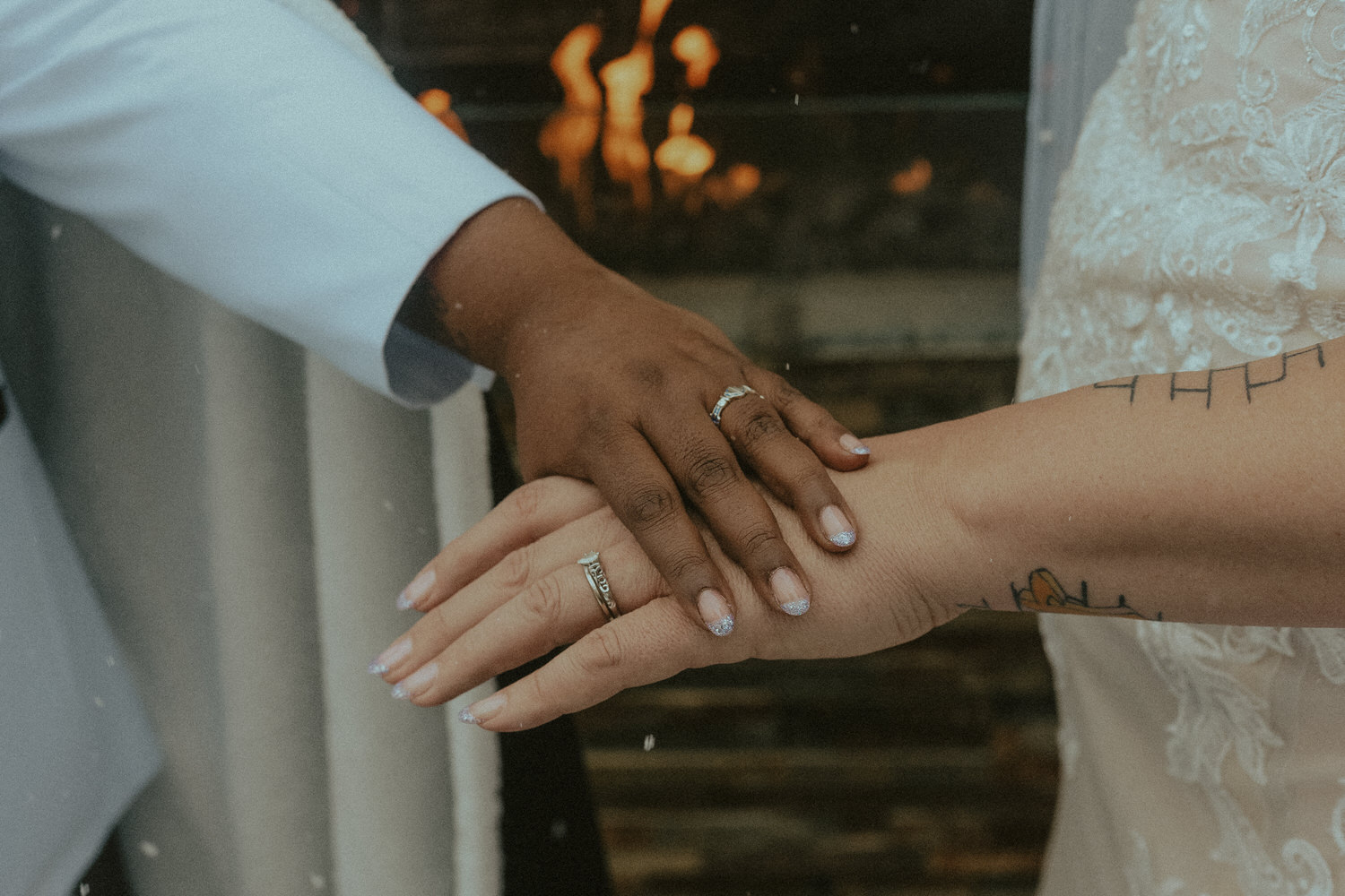 Inclusive wedding photography showing two hands laid on top of each other showcasing wedding rings.