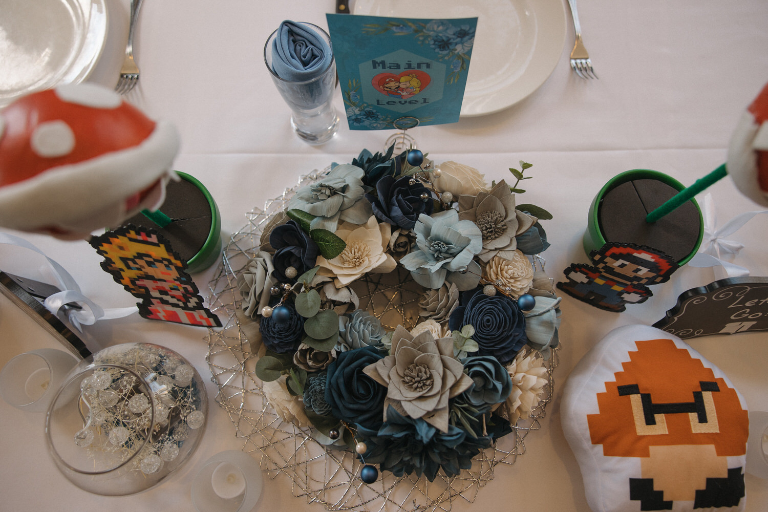 A ring of flowers sitting next to Mario decorations showcasing ideas for non-traditional weddings