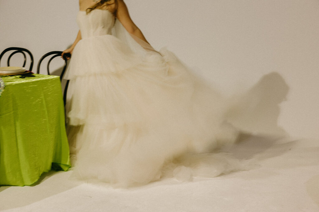 A person swinging the back of their wedding dress. 