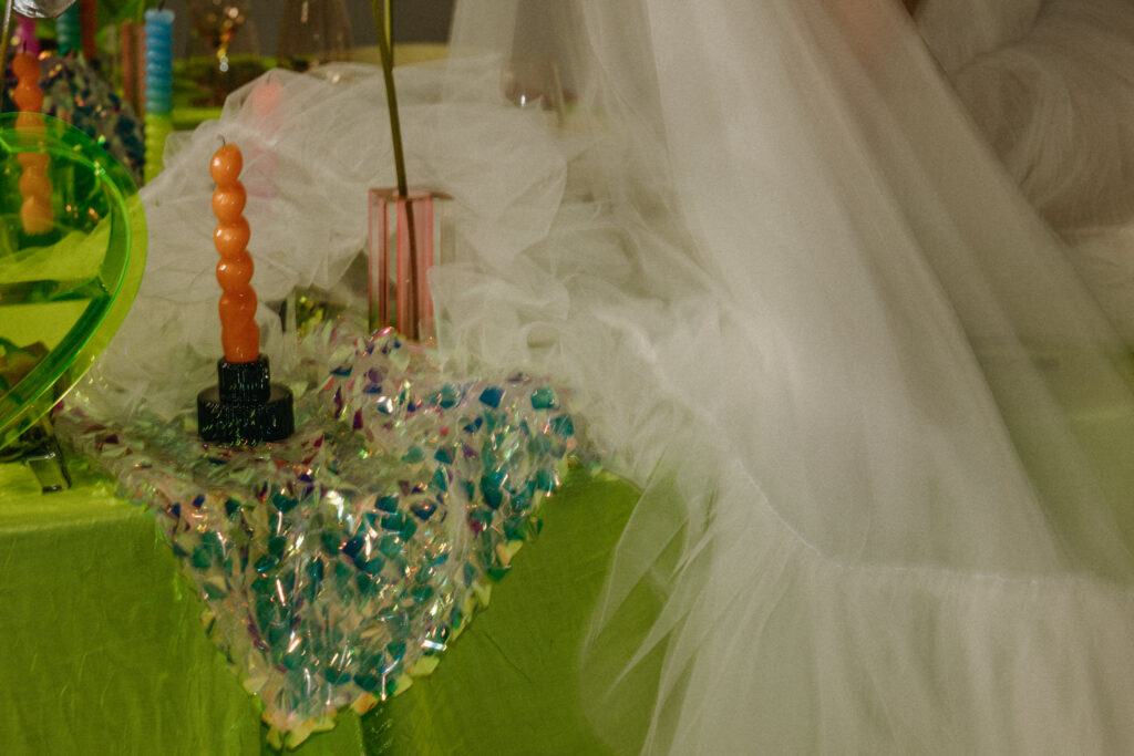 Candles and decorations hanging off the side of a table. 