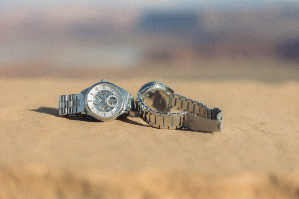 Two watches laid on a rock 