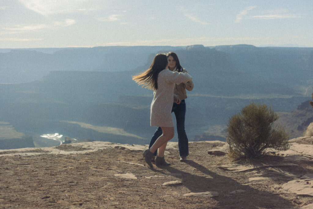 A couple dancing at the top of a canyon.